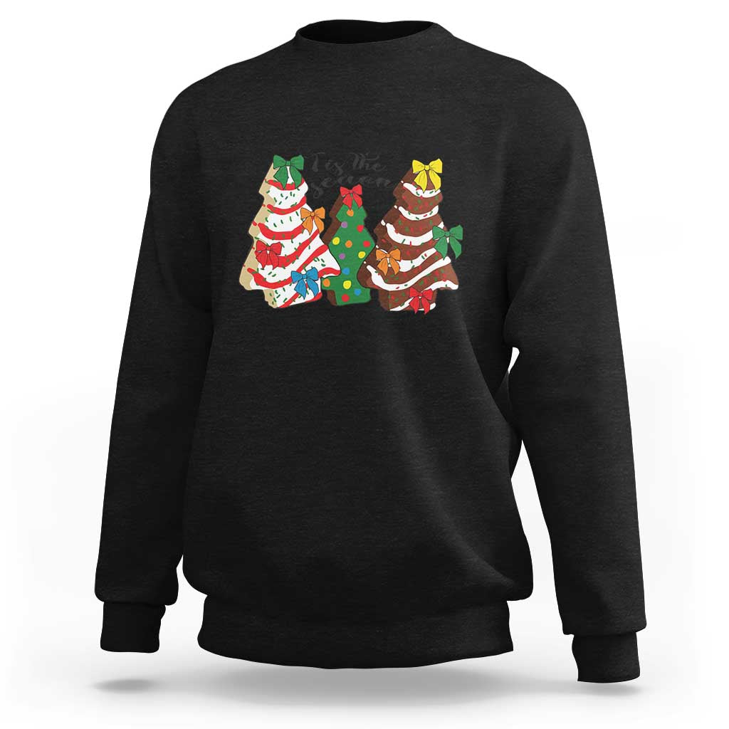 Black crewneck sweatshirt with long sleeves and colorful Christmas character graphic