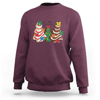 Maroon crewneck sweatshirt with long sleeves and colorful Christmas character graphic