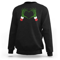 Black sweatshirt with green skeleton-heart hands graphic on chest