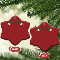 Two red snowflake-shaped Christmas ornaments with green skeleton hands and gold hanging loops