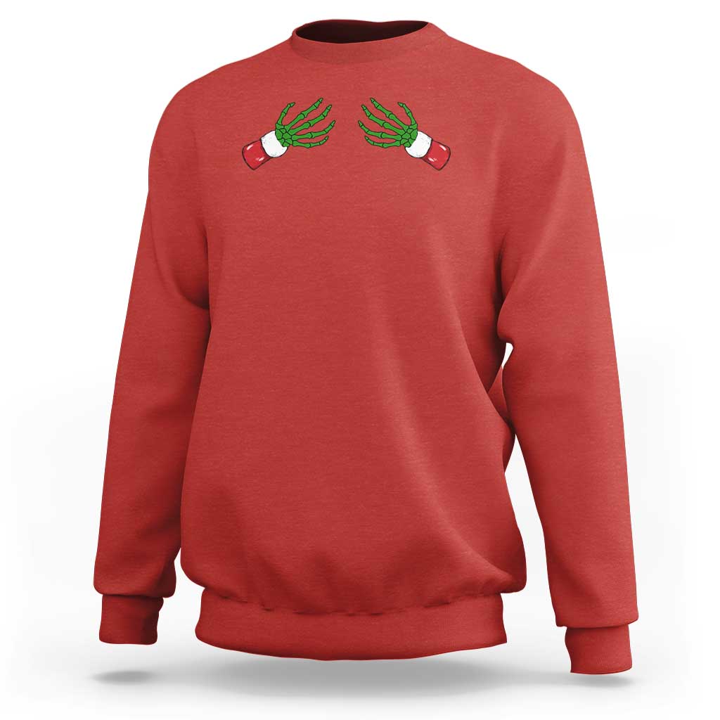 Women's Christmas sweatshirt in red, graphic green skeleton hands on front