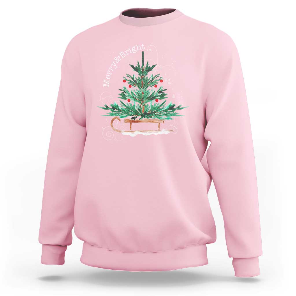 Light pink Christmas sleigh sweatshirt with colorful tree graphic on the front.