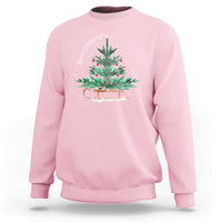 Light pink Christmas sleigh sweatshirt with colorful tree graphic on the front.