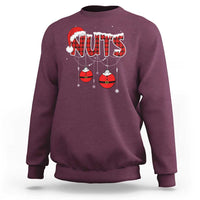 Maroon crewneck sweatshirt with 'NUTS' holiday graphic and hanging ornament balls
