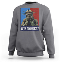 Charcoal gray sweatshirt with Statue of Liberty graphic and “WTF AMERICA?” text on chest