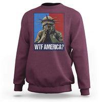 Maroon sweatshirt with Statue of Liberty graphic and “WTF AMERICA?” text on chest