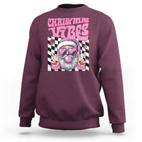 Maroon crewneck sweatshirt with pink "CHRISTMAS VIBES" Santa graphic on front