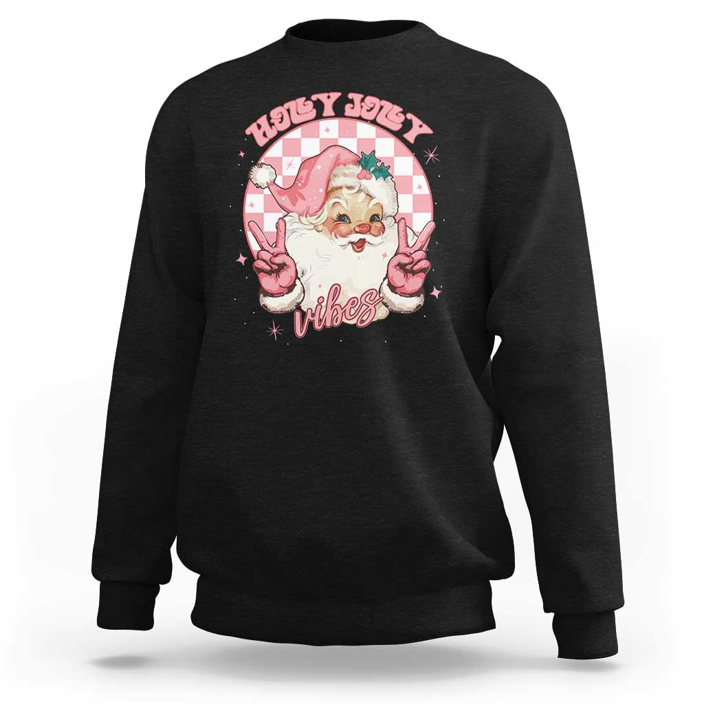 Black crewneck Christmas sweatshirt with pink Santa peace-sign graphic on chest