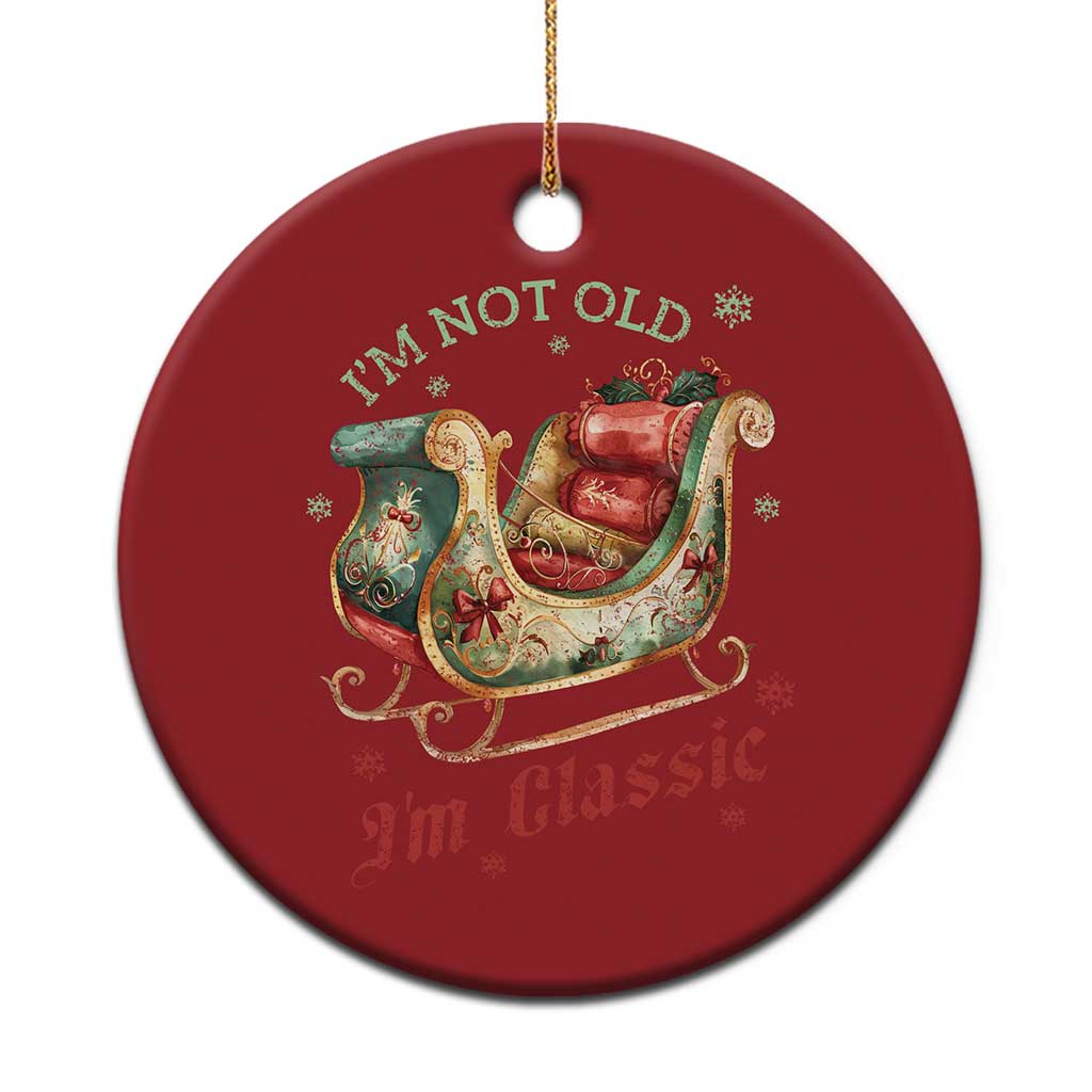 Red round Christmas ornament with Santa sleigh and “I'M NOT OLD, I'M Classic” text.