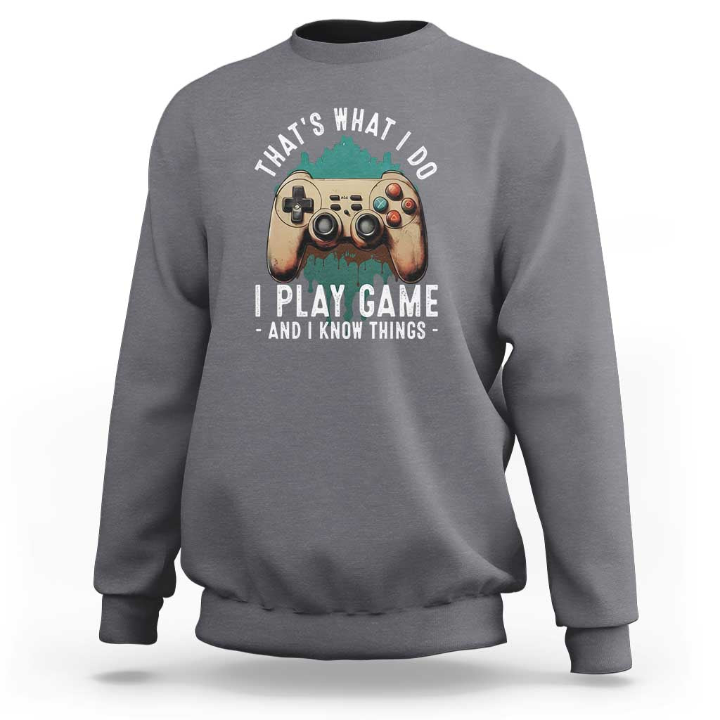 Charcoal crewneck sweatshirt with gaming controller graphic on the chest.