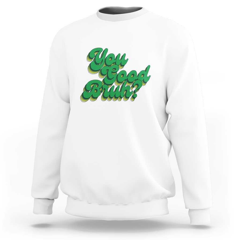 White crewneck sweatshirt with green retro “You good Bruhh” graphic on front
