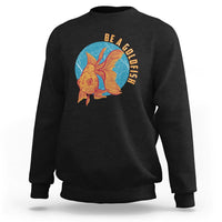 Black sweatshirt with goldfish graphic and vertical text "BE A GOLDFISH" on chest