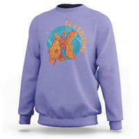 Violet sweatshirt with goldfish graphic and vertical text "BE A GOLDFISH" on chest