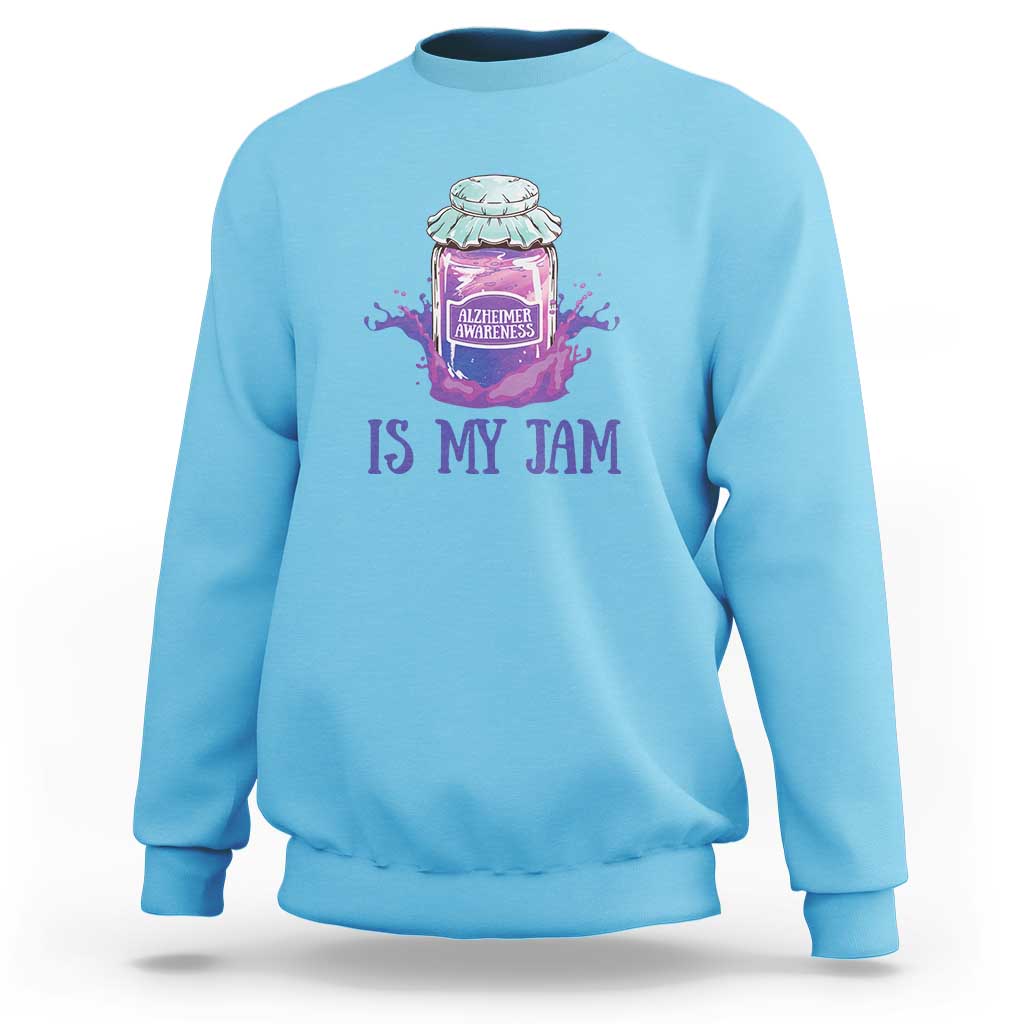 Light blue sweatshirt with “IS MY JAM” Alzheimer awareness jar graphic on chest