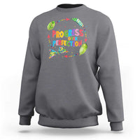 Charcoal gray sweatshirt with front graphic text "PROGRESS OVER PERFECTION" and colorful leaves