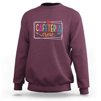 Maroon crewneck sweatshirt with long sleeves and "Cafeteria crew" graphic on chest