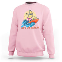 Light Pink banana surfing graphic sweatshirt with “LET’S GO BANANA” text on front