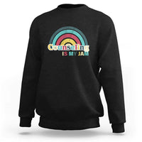 Black sweatshirt with ribbed crew neck and front rainbow “Counseling Is My Jam” graphic
