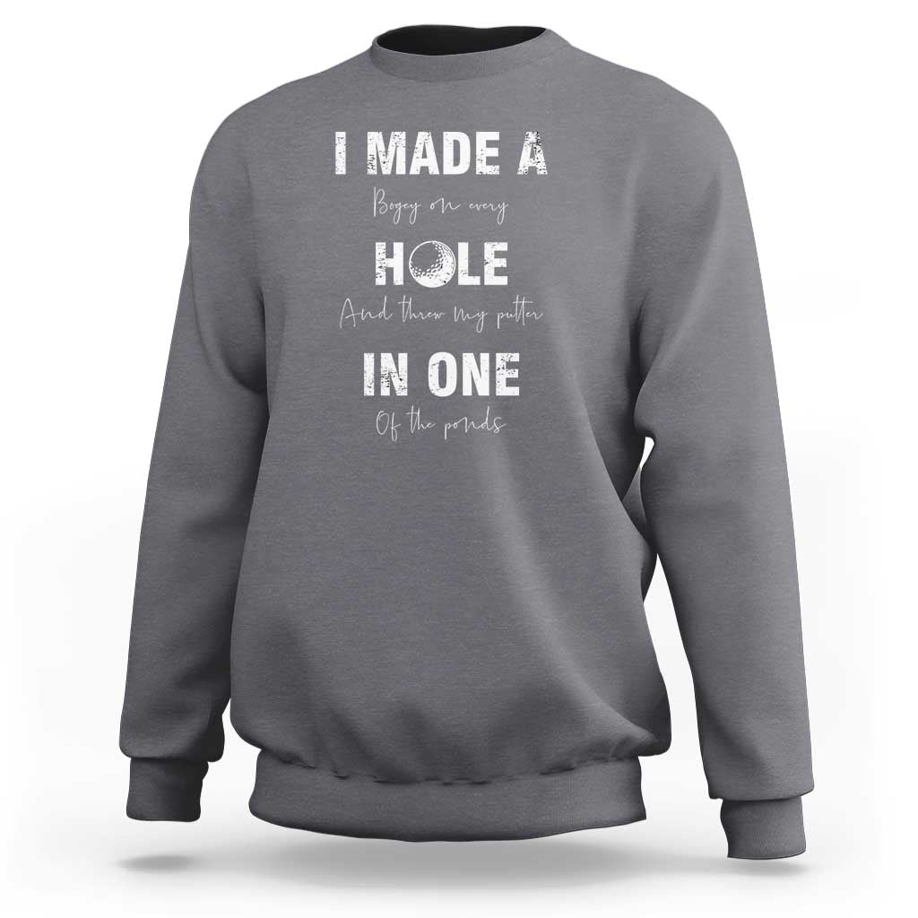 Charcoal gray golf sweatshirt with 'I made a hole in one' front graphic