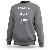 Charcoal gray golf sweatshirt with 'I made a hole in one' front graphic