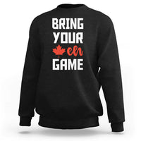 Black sweatshirt with “BRING YOUR EH GAME” text and orange maple leaf graphic