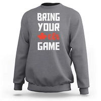 Dark heather gray sweatshirt with “BRING YOUR EH GAME” text and orange maple leaf graphic