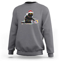 Light gray sweatshirt with embroidered cat in a Santa hat and colorful holiday lights graphic