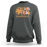Dark gray crewneck sweatshirt with “Love Fall (prevention)” autumn leaf graphic, long sleeves.