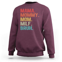 Maroon sweatshirt with colorful text graphic: “MAMA MOMMY MOM MILF BRUH.”