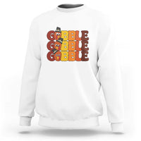 White sweatshirt with "GOBBLE GOBBLE" turkey graphic on the chest