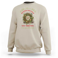 Sand color crewneck sweatshirt with holiday wreath and pentagram graphic