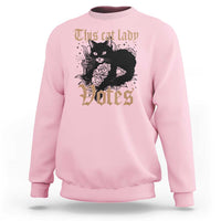 Light pink sweatshirt with cat-and-roses "Votes" graphic at center
