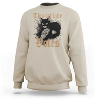 Beige sweatshirt with cat-and-roses "Votes" graphic at center