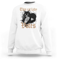 White sweatshirt with cat-and-roses "Votes" graphic at center