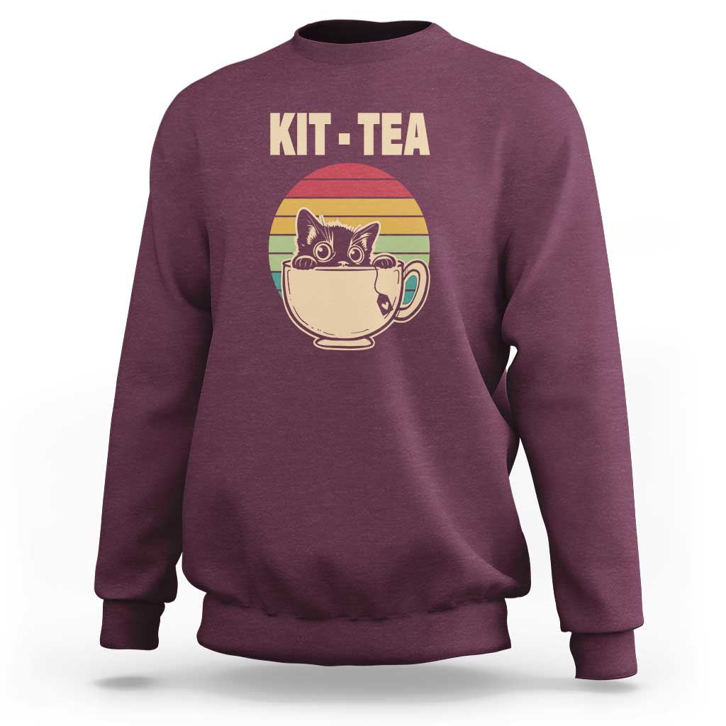 Maroon crewneck sweatshirt with 'KIT-TEA' cat in tea cup graphic