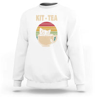 White crewneck sweatshirt with 'KIT-TEA' cat in tea cup graphic