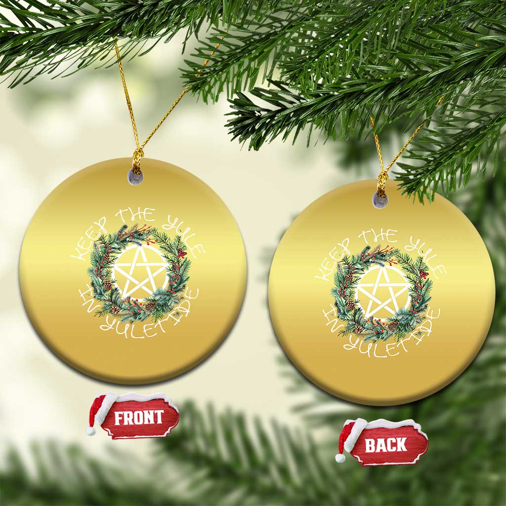 Two gold round Christmas ornaments with wreath and nativity star, hanging loops