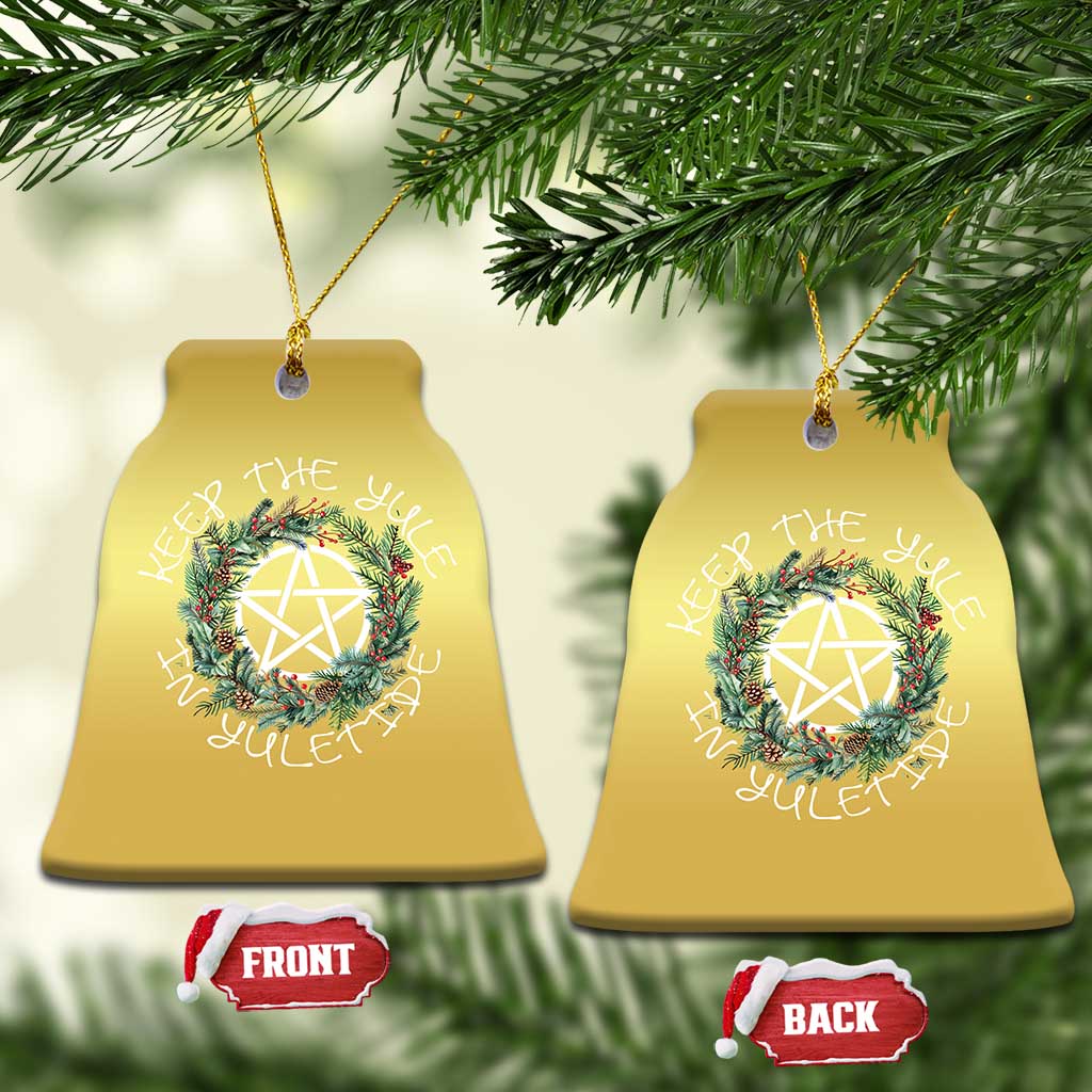 Gold bell-shaped Christmas ornament with wreath and nativity star, hanging loop