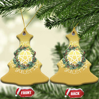 Two gold bell-shaped Christmas ornaments with wreath and nativity star, hanging loops