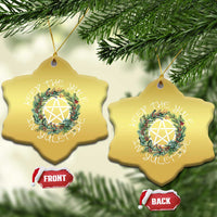 Two gold star-shaped Christmas ornaments with wreath and nativity star, hanging loops