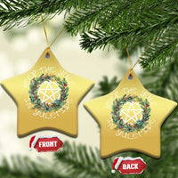 Gold star-shaped Christmas ornament with wreath and nativity star, hanging loop