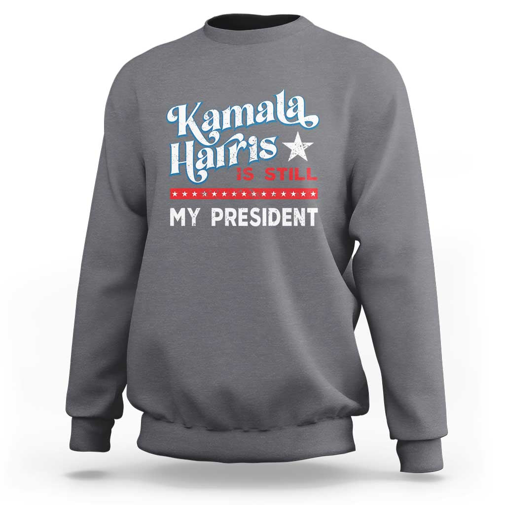 Charcoal gray crewneck sweatshirt with vintage star “Kamala Harris is still my president” print