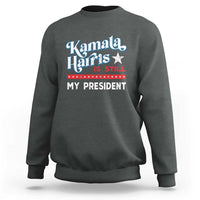 Dark heather gray crewneck sweatshirt with vintage star “Kamala Harris is still my president” print