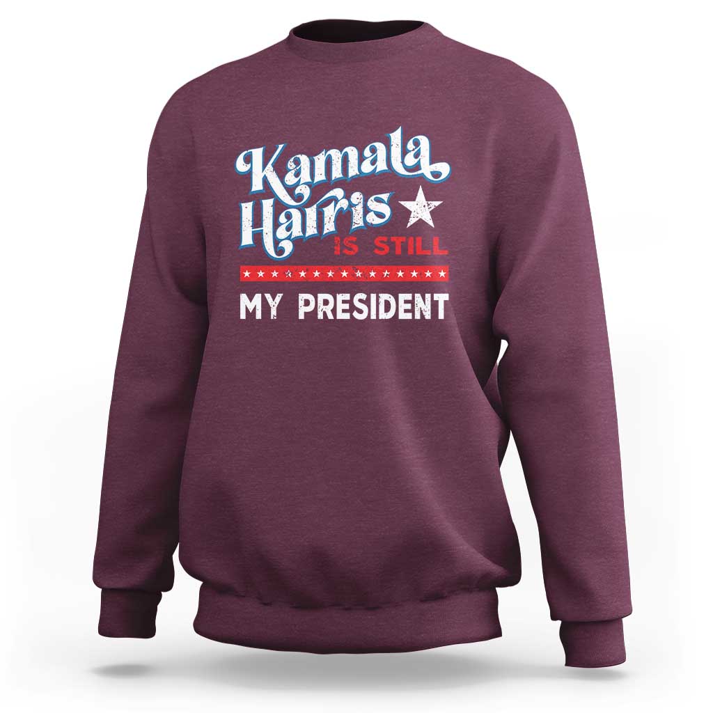 Maroon crewneck sweatshirt with vintage star “Kamala Harris is still my president” print