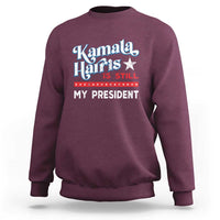 Maroon crewneck sweatshirt with vintage star “Kamala Harris is still my president” print