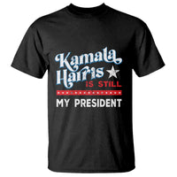 Black graphic t-shirt with star and 'Harris Is Still My President' print