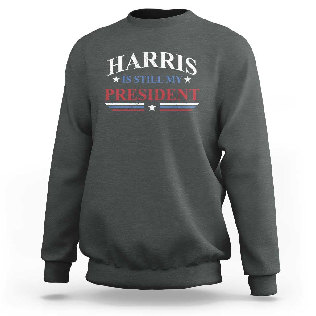 Charcoal crewneck sweatshirt with Harris "Still My President" star-striped graphic