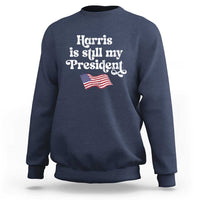 Navy sweatshirt with 'Harris is still my President' text and mini American flag graphic