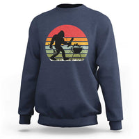 Navy crewneck sweatshirt with Bigfoot BBQ chef graphic in red sunset circle