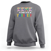 Dark heather gray crewneck sweatshirt with colorful unicorn graphic and “Dare to be yourself” text
